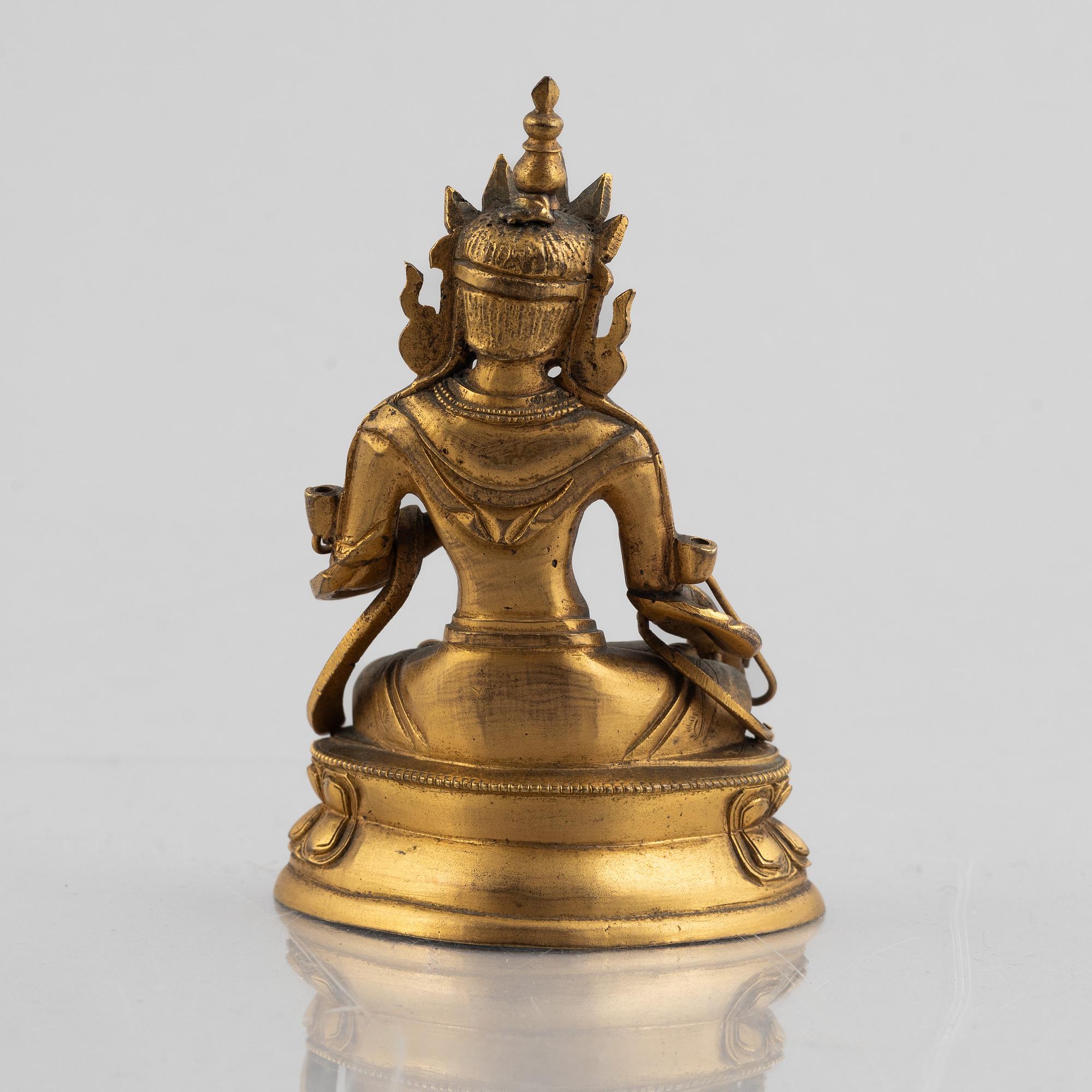 A gilt copper figure of a Buddha, 20th century.
