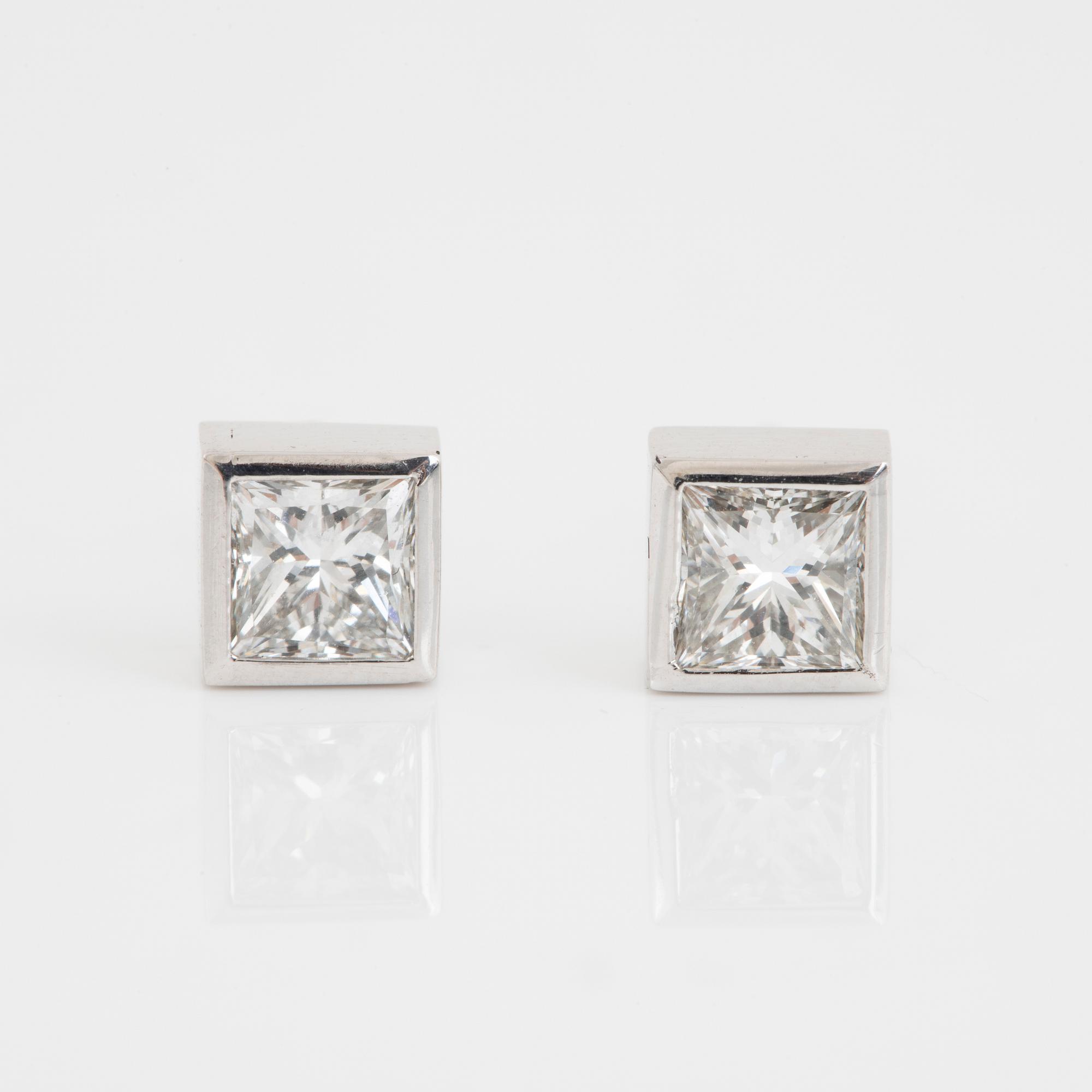 A pair of square modified brilliant cut diamond earrings.
