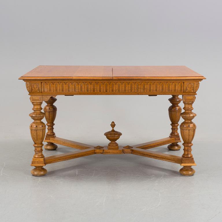 An oak Baroque-style dining table, around 1900.