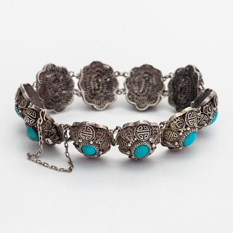 A bracelet and pair of earrings in silver with turquoises. Import marked Risto Aho, Helsinki 1964.