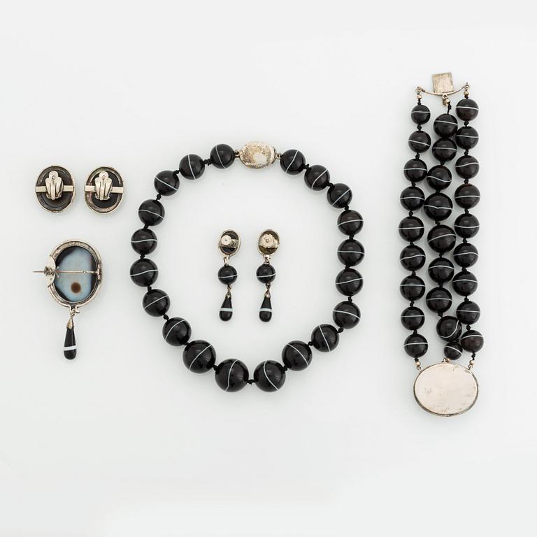 A banded agate and silver parure comprising a necklace, a bracelet, two pair of earrings and a brooch.