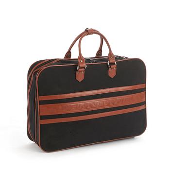 YVES SAINT LAURENT, a black canvas and brown leather suitcase.