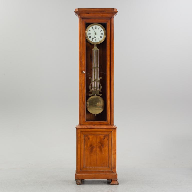 A walnut long case clock, from around the year 1900.