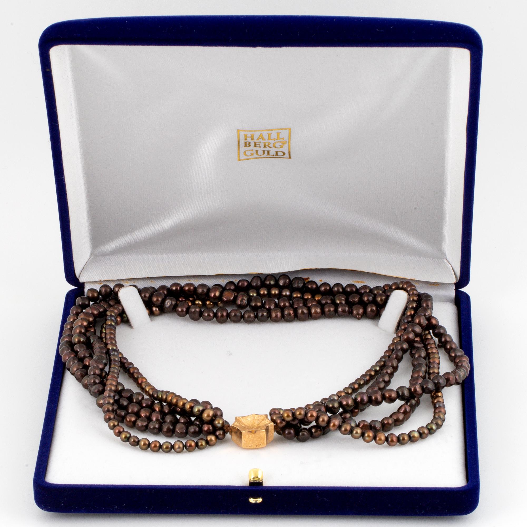 A five strand cultured pearl necklace.