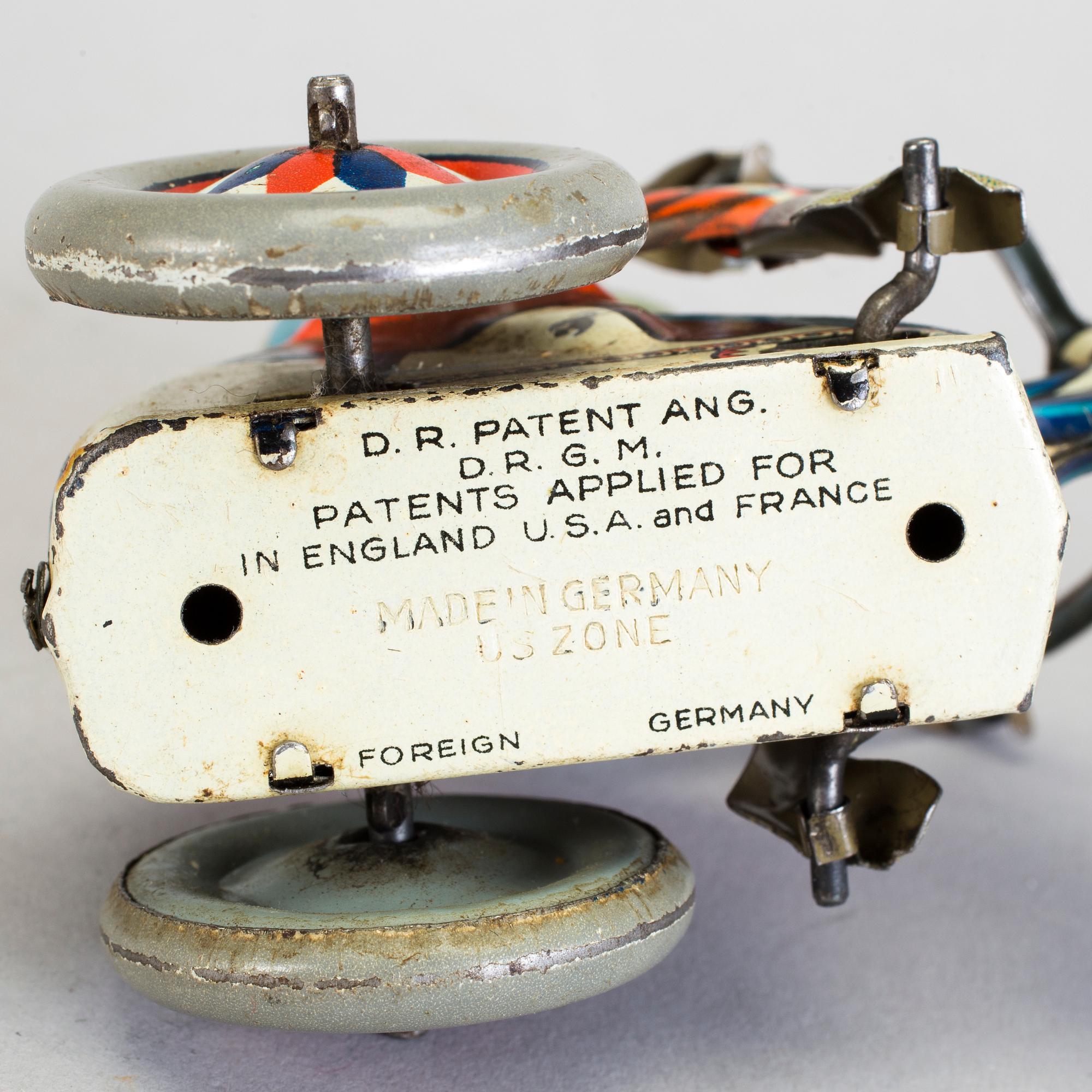 A lot of three tinplate toys Japan and Germany 1950s.