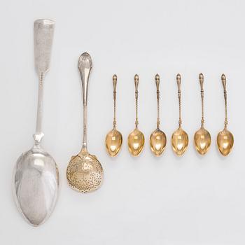 Six gilt coffee spoons, a parcel-gilt serving spoon and sifter spoon, maker's mark of Hj. Fagerroos, Helsinki 1896-1929.