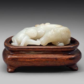 587. A Chinese nephrite figure of a reclining horse and a monkey, early 20th Century.