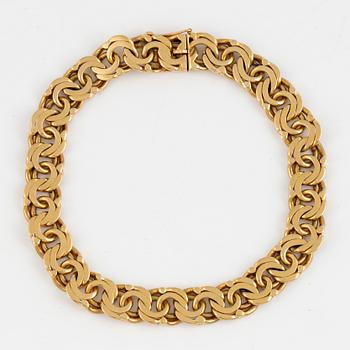 An 18K gold bracelet.
