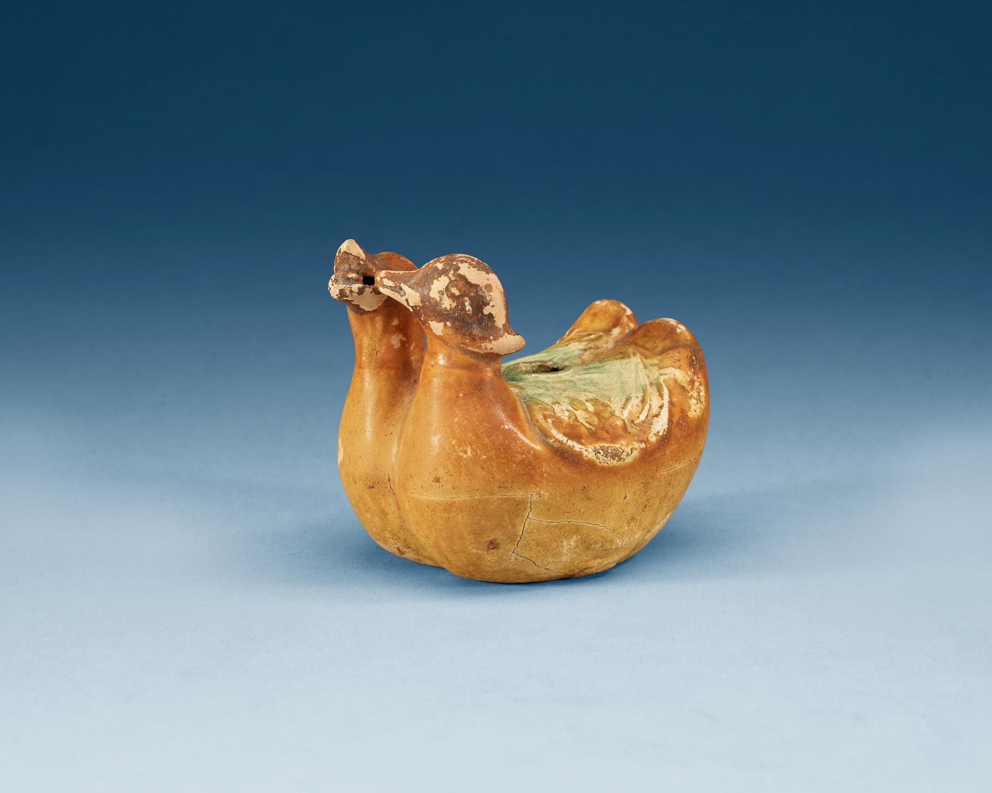 A yellow and green glazed figurine of two mandarin ducks. Ming dynasty ( 1368-1644).