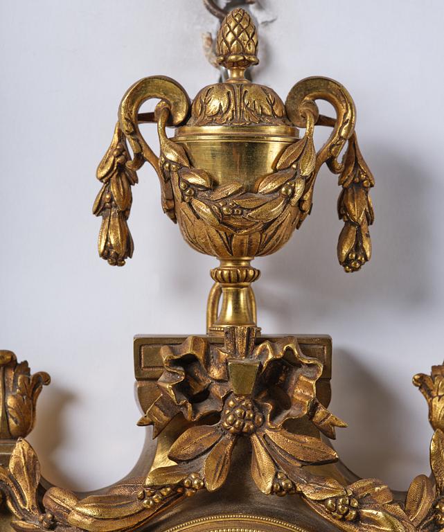 A French  Louis XVI-style wall clock, around 1900.