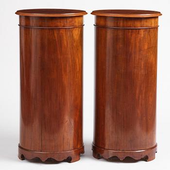 A pair of late Empire mahogany column cabinets, mid 19th Century.