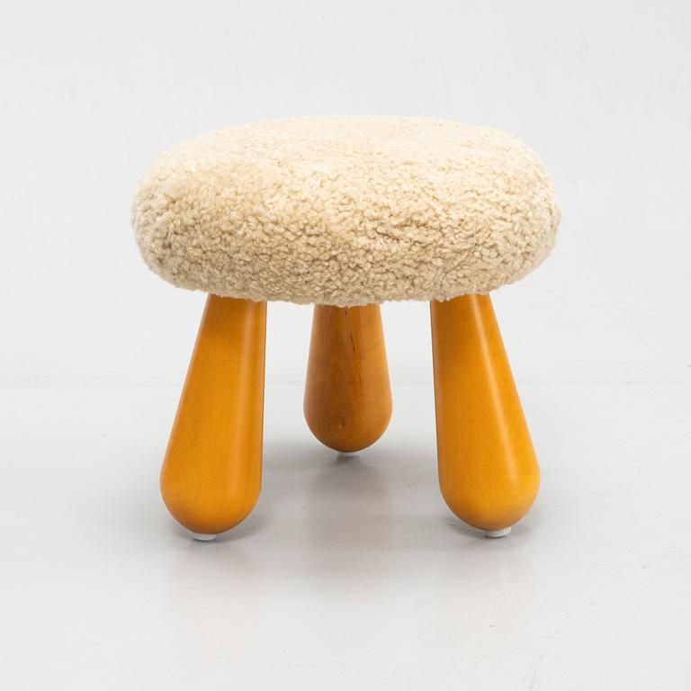 A contemporary stool with birch legs and new sheepskin upholstery.