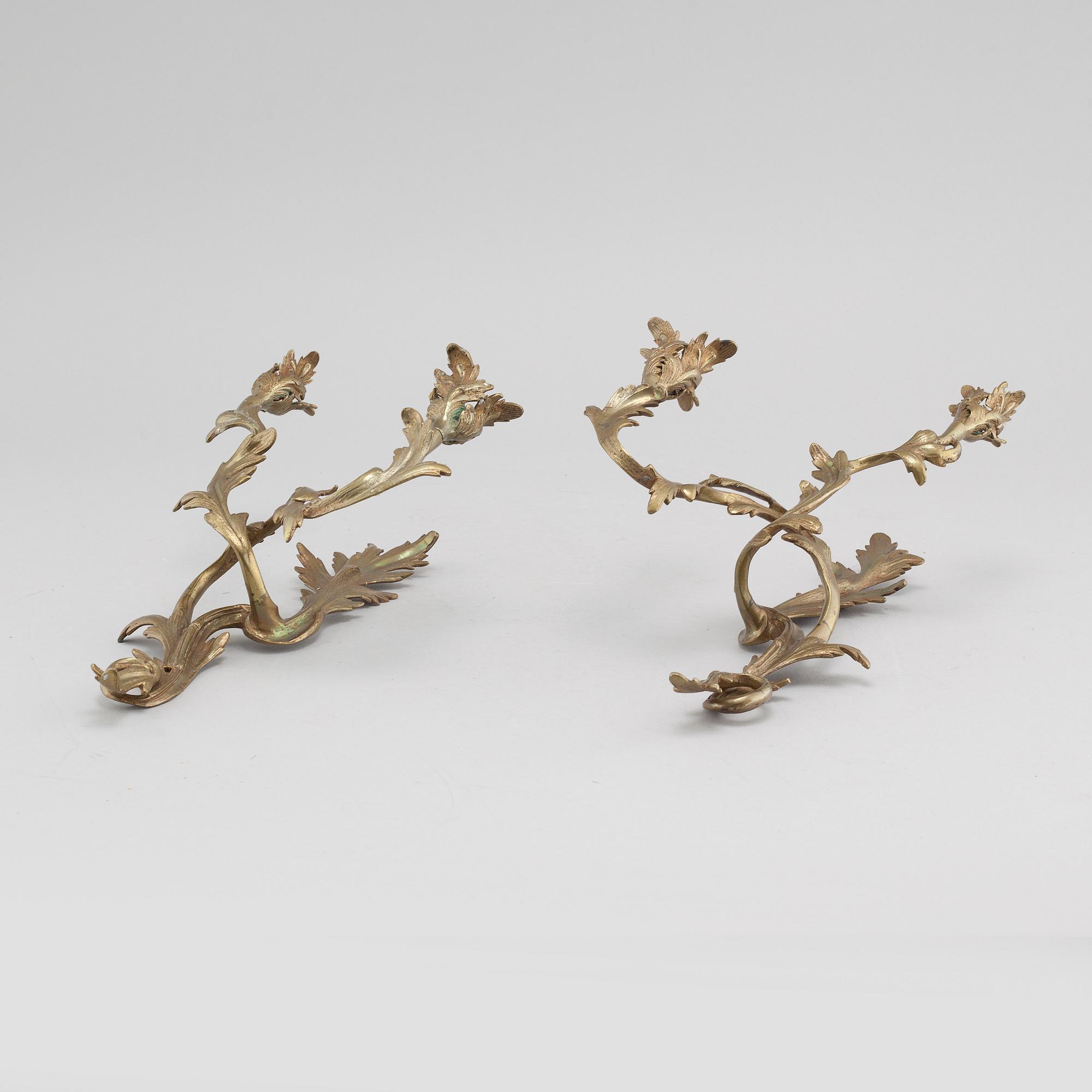 A pair of Louis XV-style brass wall sconces first half of the 20th century.