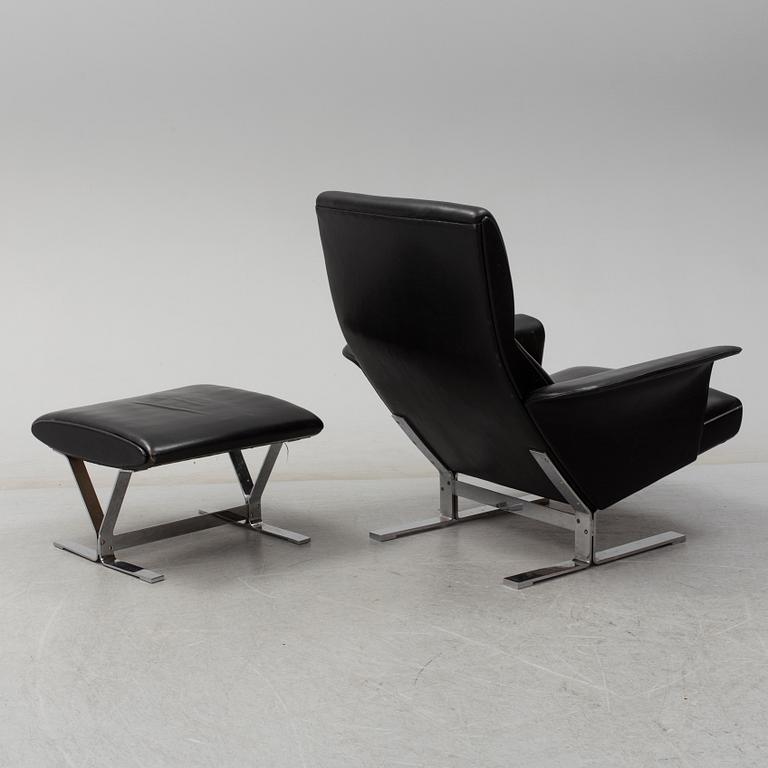 A second half of the 20th century easy chair and stool by Georg Thams, Vejens Polstermöbelfabrik, Denmark.