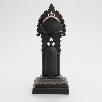 A neo-gothic cast iron pocket watch stand with a pocket watch. 19th century.