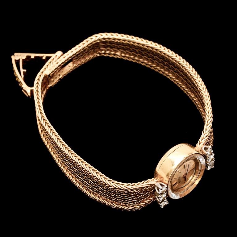 DAMARMBANDSUR, Omega Turler, länk i 18k guld. Med 5 briljantslipade diamanter tot ca 0,25 ct. Vikt tot ca 27 g.