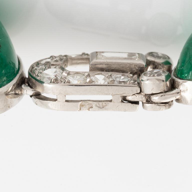 An art deco platinum necklace/bracelet combination with cabochon-cut emeralds.