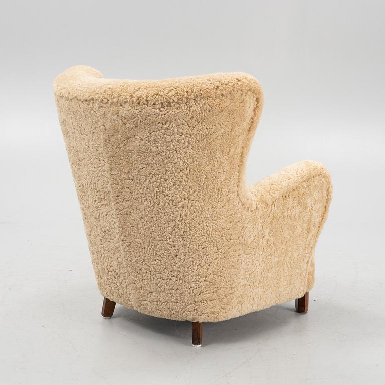 A 1940s lounge chair from Slagelse, in new sheepskin upholstery.