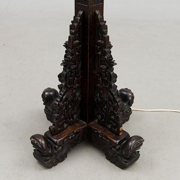 A Chinese carved wood floor lamp from the first half of the 20th Century.