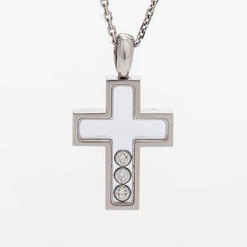 Chopard, an 18K whitegold 'Happy Diamonds" cross necklace set with diamonds.
