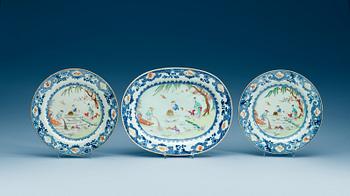 1724. A famille rose serving dish and two dinner plates, Qing dynasty, Qianlong (1736-95).