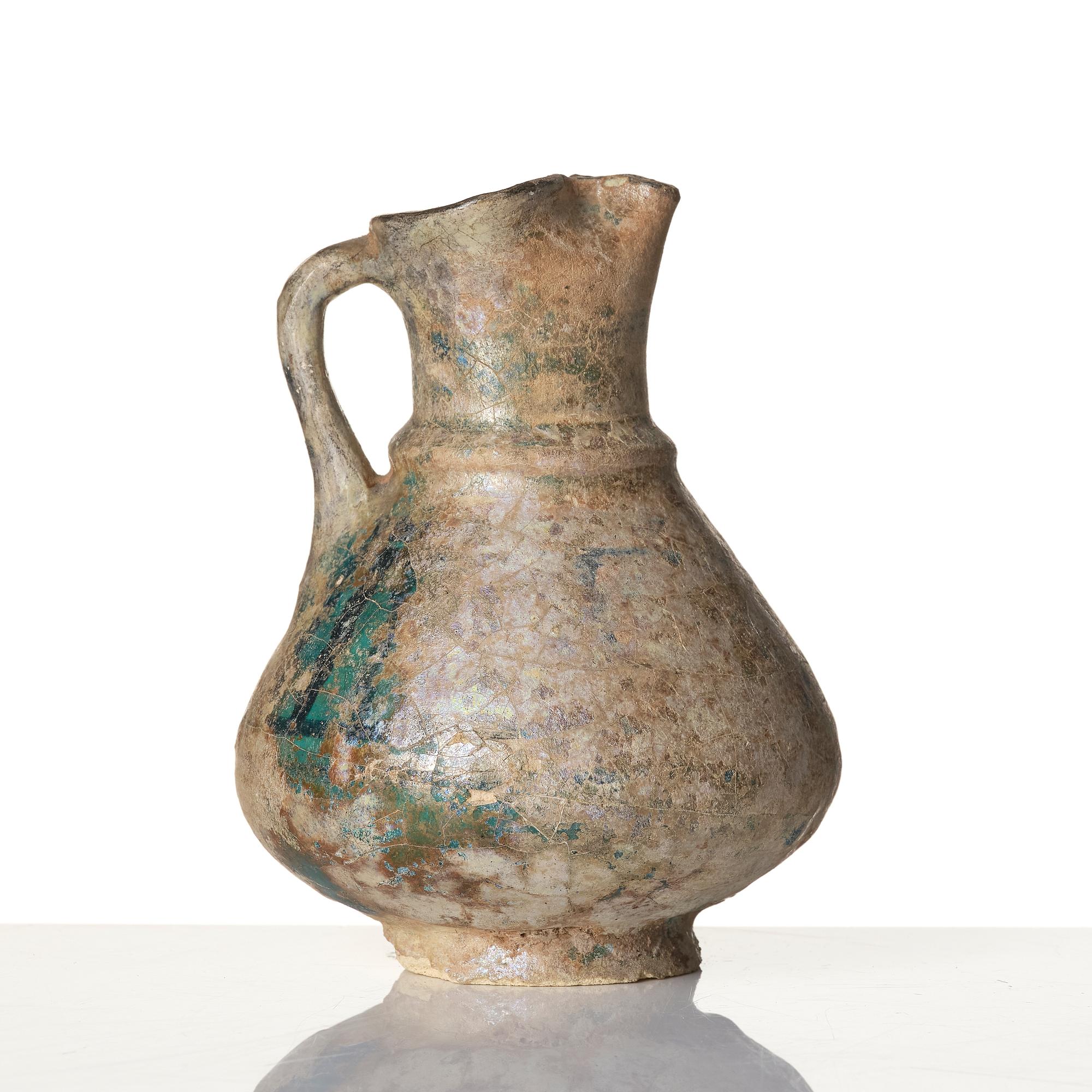 A turquoise-glazed Keshan jug, Persian, 13th century.