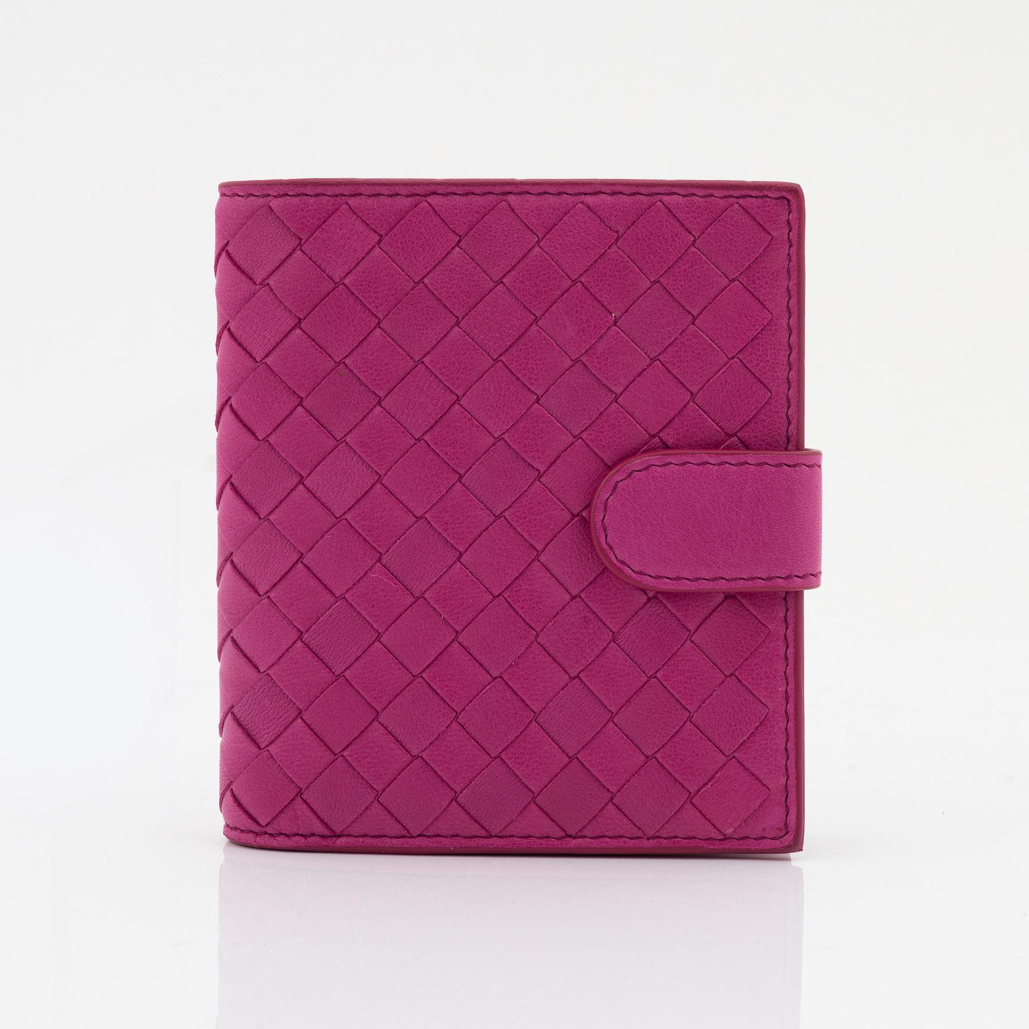 Bottega Veneta, a cerise leather wallet.