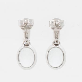 A pair of 18K white gold earrings set with oval faceted aquamarines and round brilliant-cut diamonds.