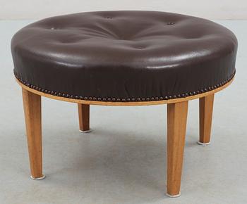 A Josef Frank mahogany and brown leather stool by Svenskt Tenn.