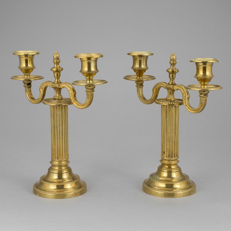 A pair of french 18th century brass candelabras.