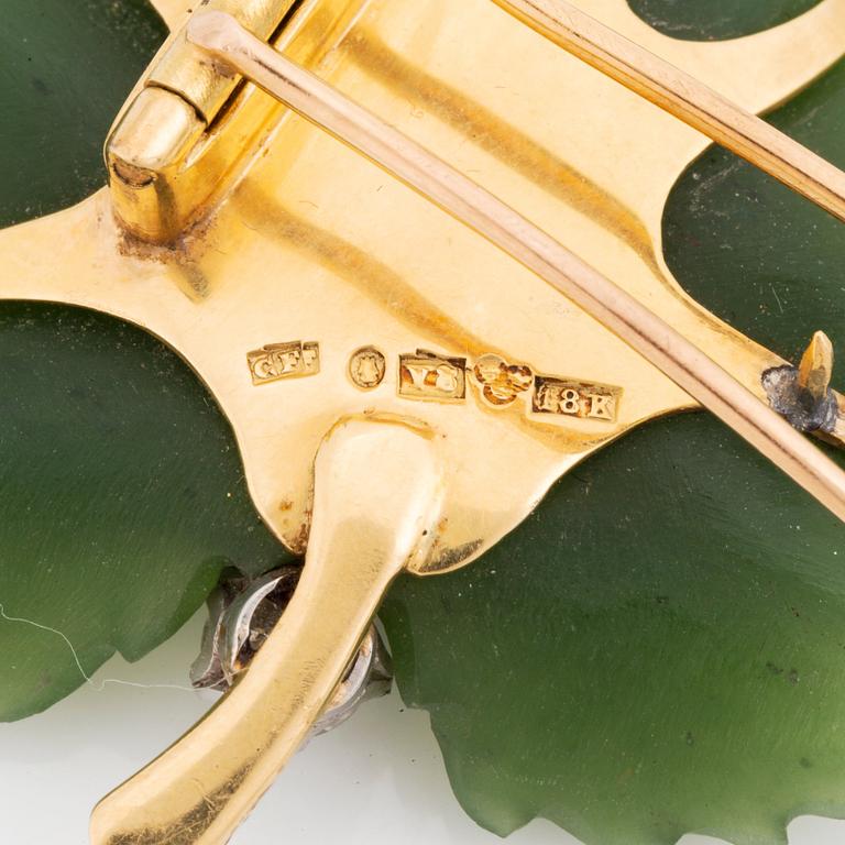 An 18K gold and nefrite Borgila brooch set with an old-cut diamond.