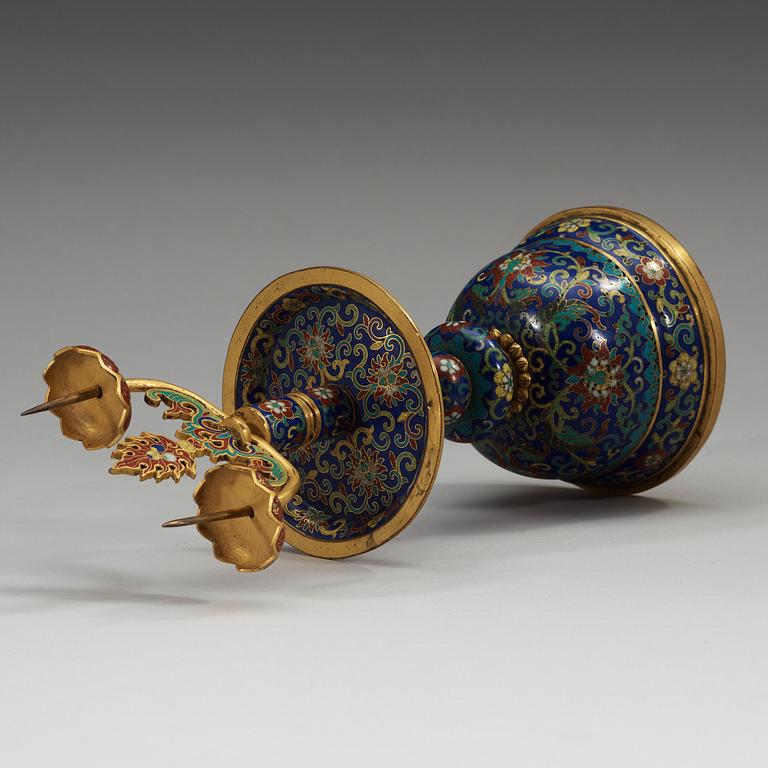 A fine Cloisonné candlestick holder with floral scrolls against a deep blue back ground, Qing dynasty, 18th Century.
