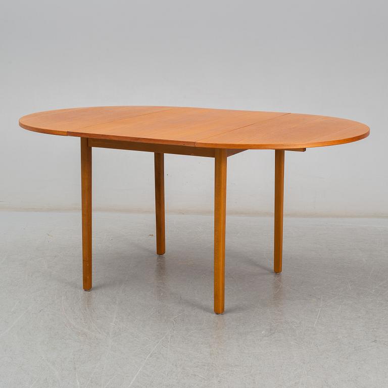 A second half of the 20th century teak veneered dining table.