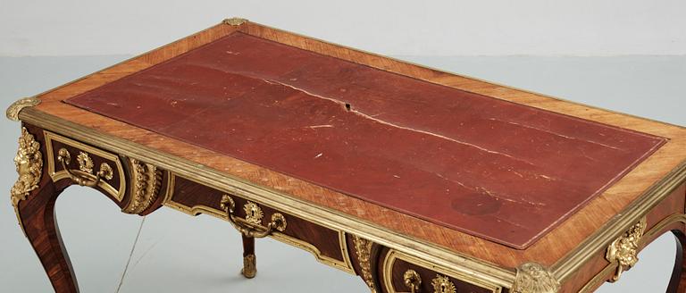 A Louis XV-style writing desk, circa 1900.