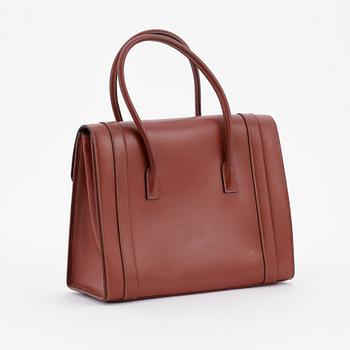 HERMÈS, a brown leather handbag.