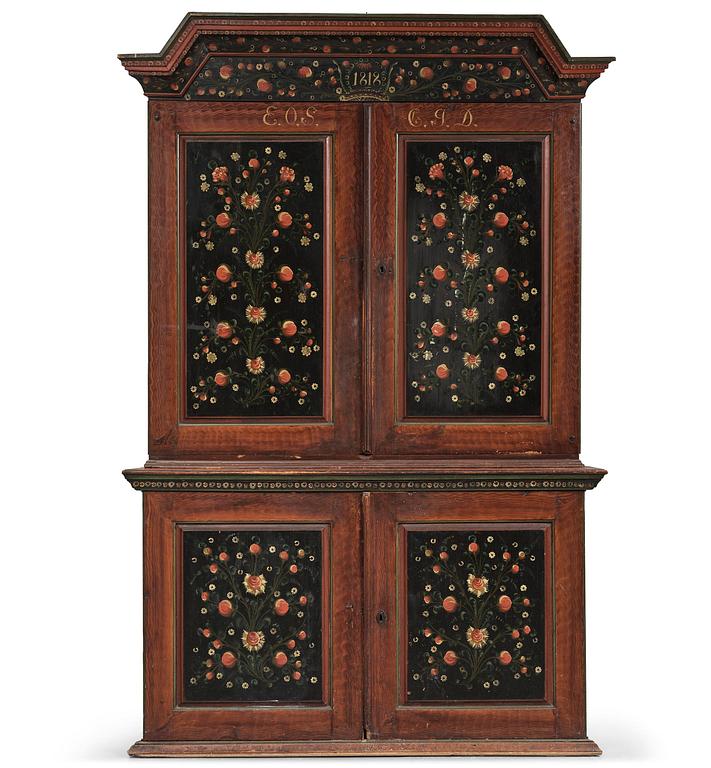 A Swedish polychrome painted folk art corner cabinet, dated 1818.