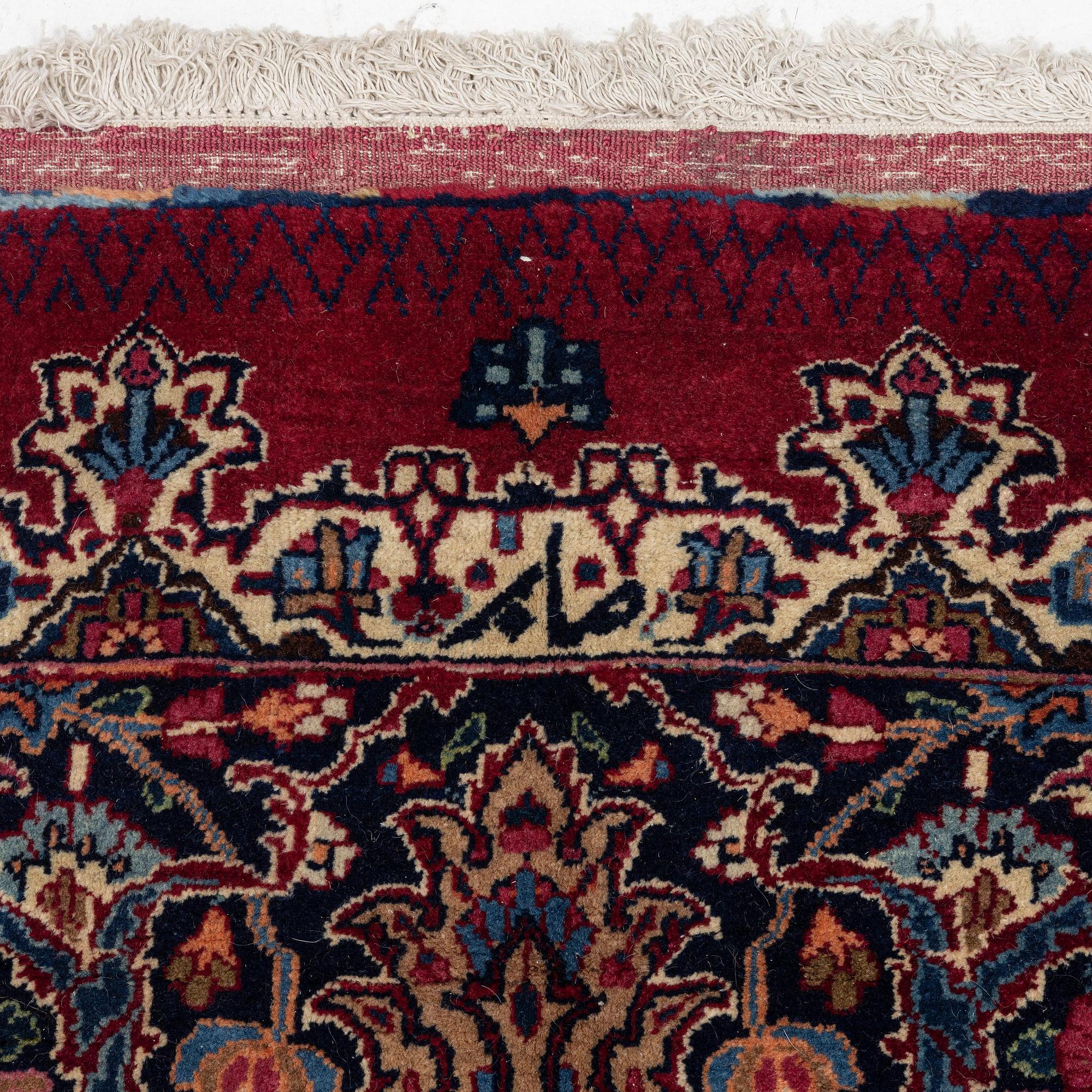 A Mashad carpet, signed Saber, c. 468 x 348 cm.