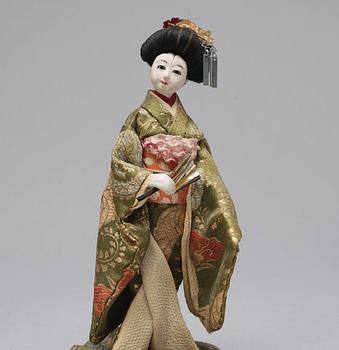 Two Japanese dolls and a box with minitures, 20th Century.