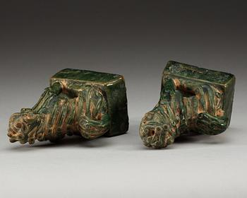 A pair of green glazed figures of 'Buddhist Lions', Ming dynasty.