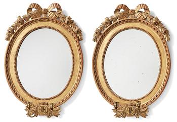 117. A pair of two-branch Gustavian-style giltwood mirrored girandoles, 19th century.