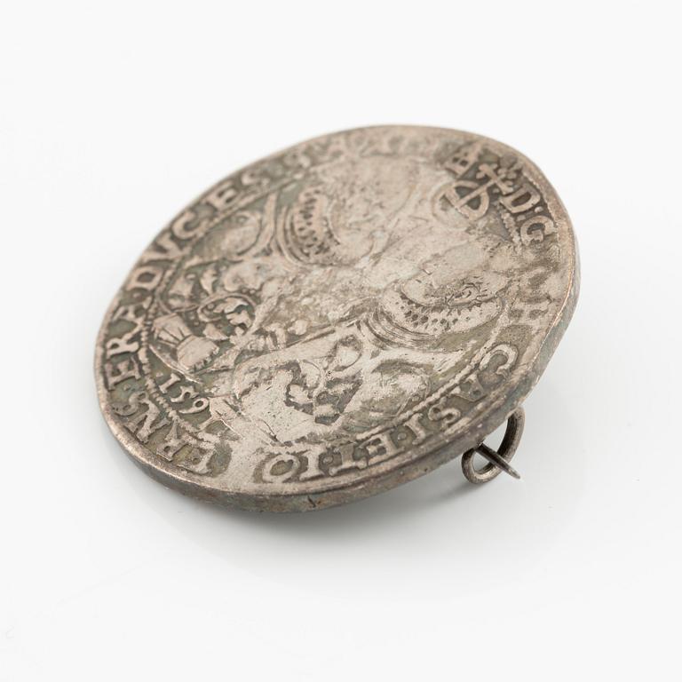 Two bracelets, a brooch, and a pendant with coins.