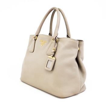 A tote/crossbody handbag by Prada.