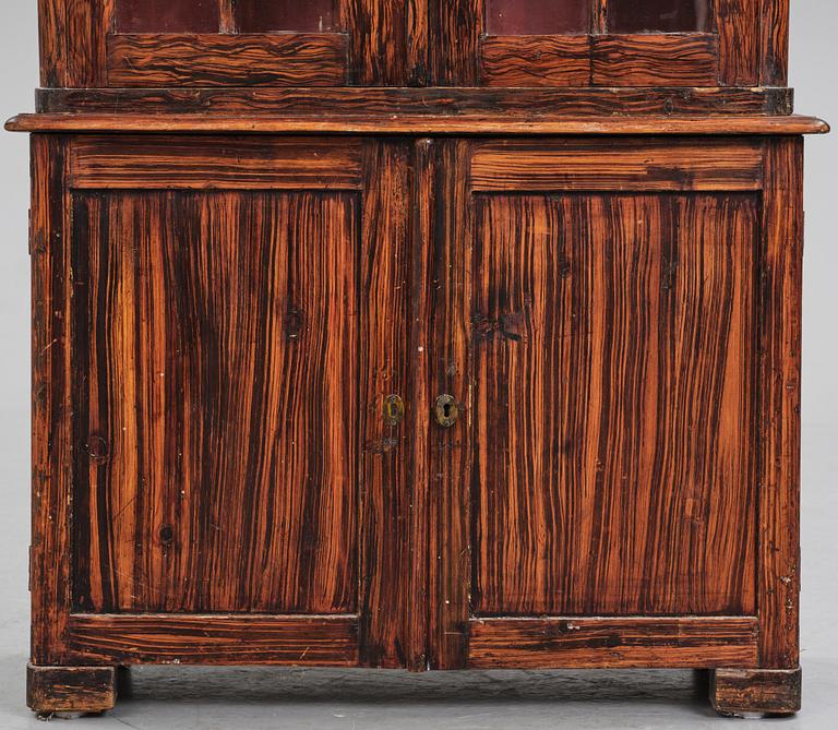 A Swedish faux-boix neo-gothic book cabinet, ca 1830.