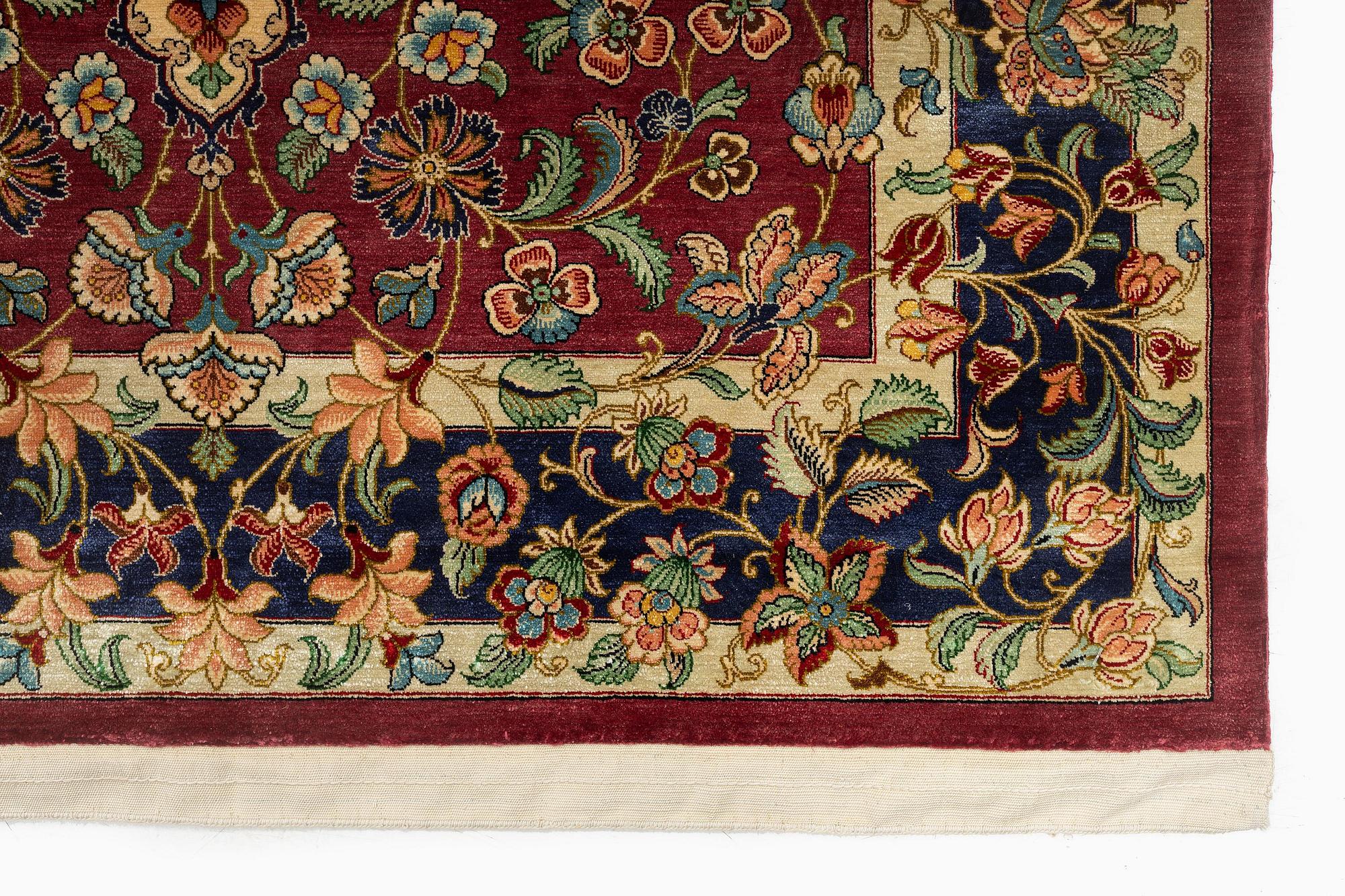 A silk Qum rug, Central Iran, signed, c. 170 x 101 cm.