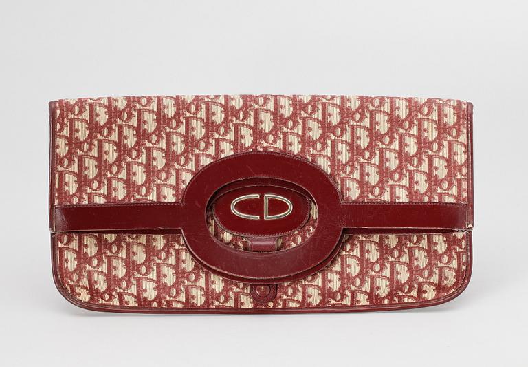 A red monogram canvas handbag by Christian Dior.