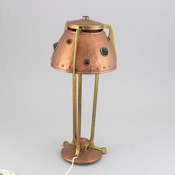An early 20th century, brass and copper table lamp.