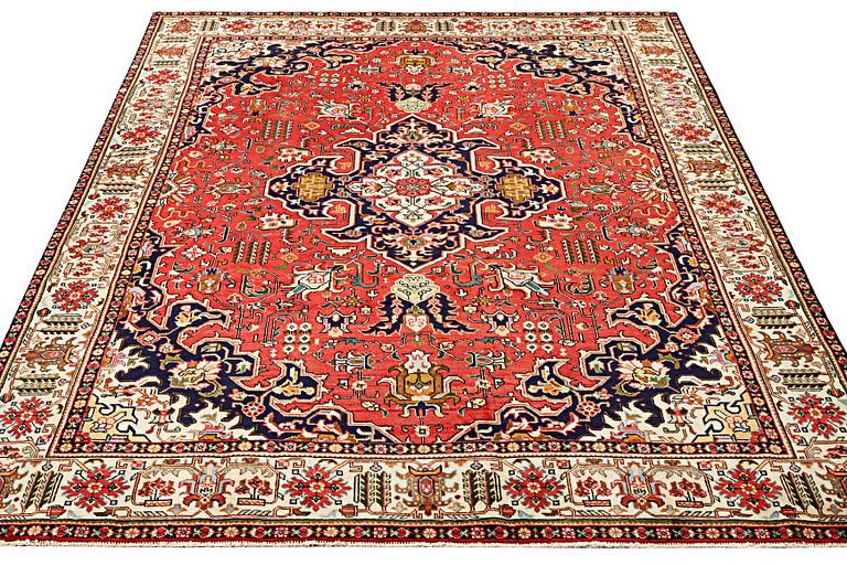 A Tabriz carpet, c. 335 x 257 cm.
