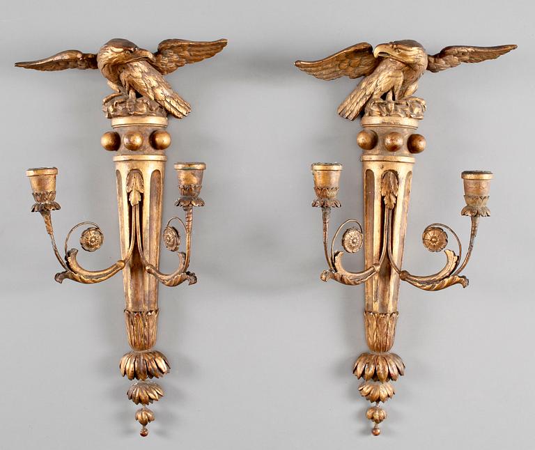 A pair of Regency-style 19th century two-light wall-lights.