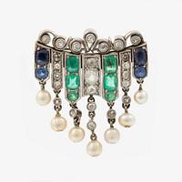 Brooch in platinum set with old-cut diamonds, sapphires, emeralds, and pearls.