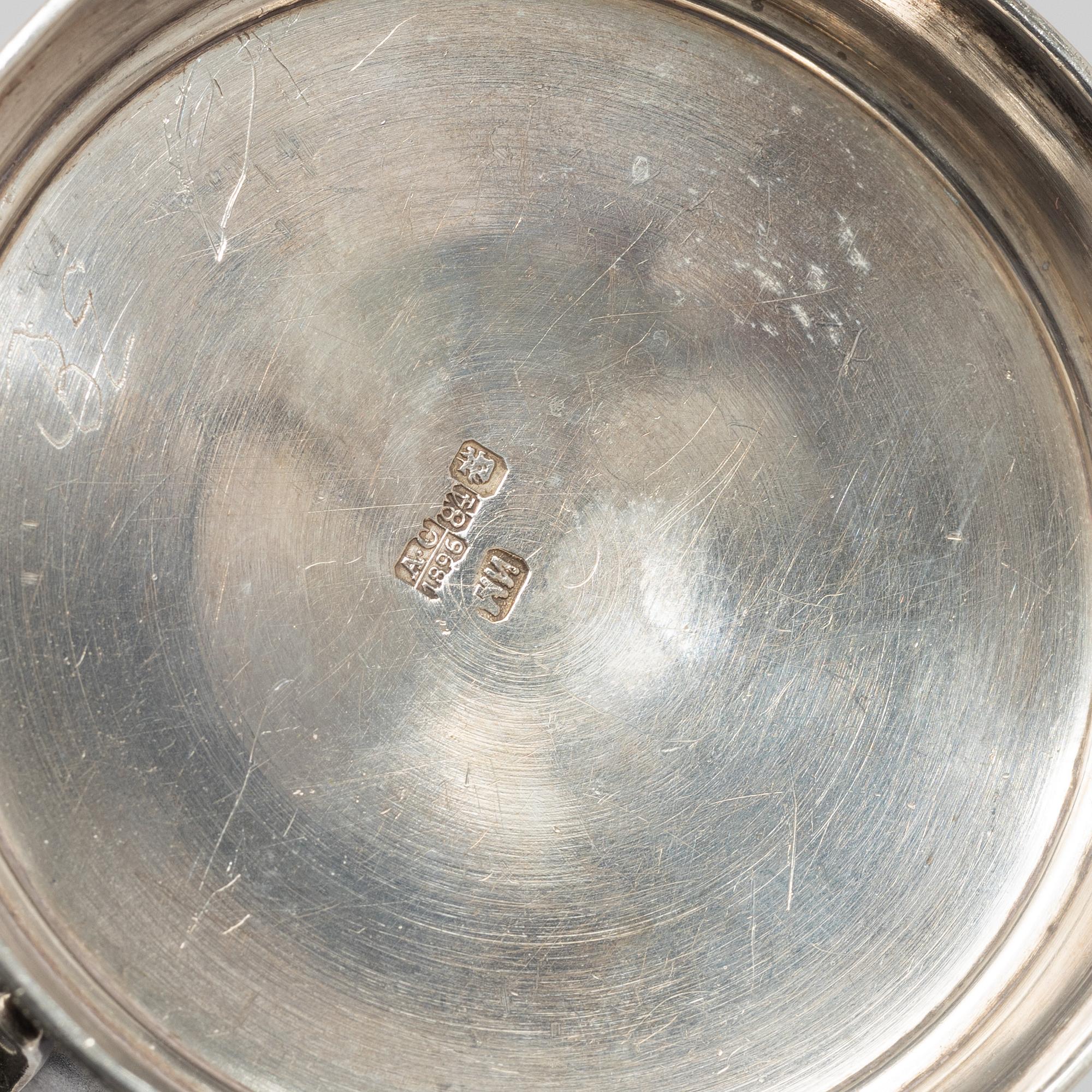 A Russian Silver Candlestick, 1908-26, and a Russian Silver Tea Glass Holder, assay master A. Skovronsky, Moscow 1896.